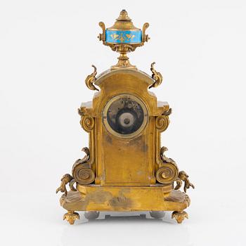 A French mantel clock, two urns and two depicters, second half of the 19th Century.