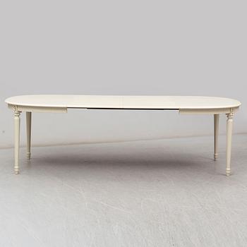 A dining table and 4 chairs, second half of the 20th century. 2 leaves included.