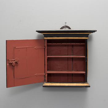 A 18th century wall cabinet.