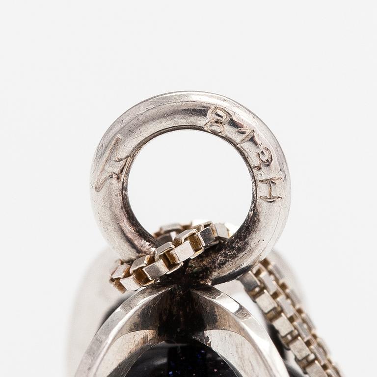 Elis Kauppi, A silver necklace with a purple goldstone. Kupittaan kulta, Turku.