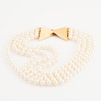 Kristian Nilsson, a four strand cultured pearl necklace with an 18K gold clasp, , Stockholm 1985.