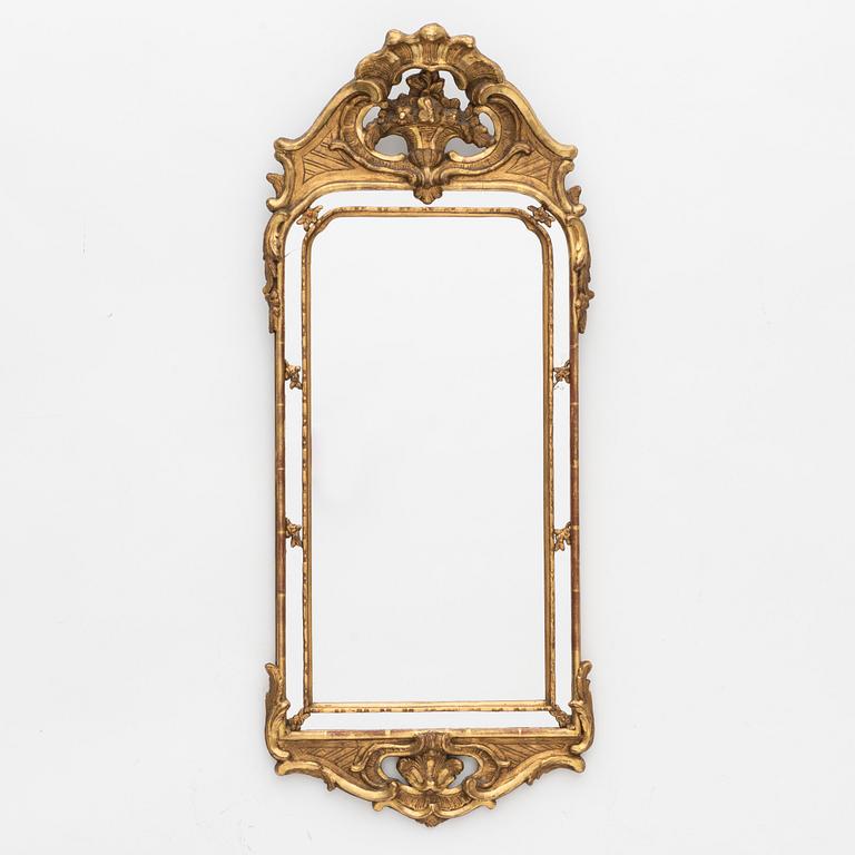 A Rococo style mirror, circa 1900.