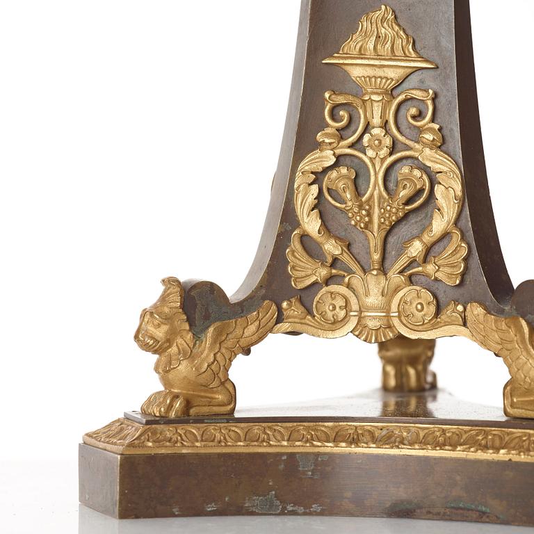 A pair of French Empire early 19th century gilt and patinated bronze four-light candelabra.