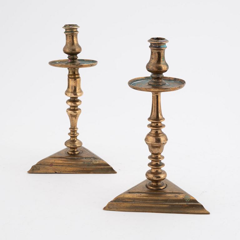 A set of two late baroque style brass candlesticks, 19th Century.