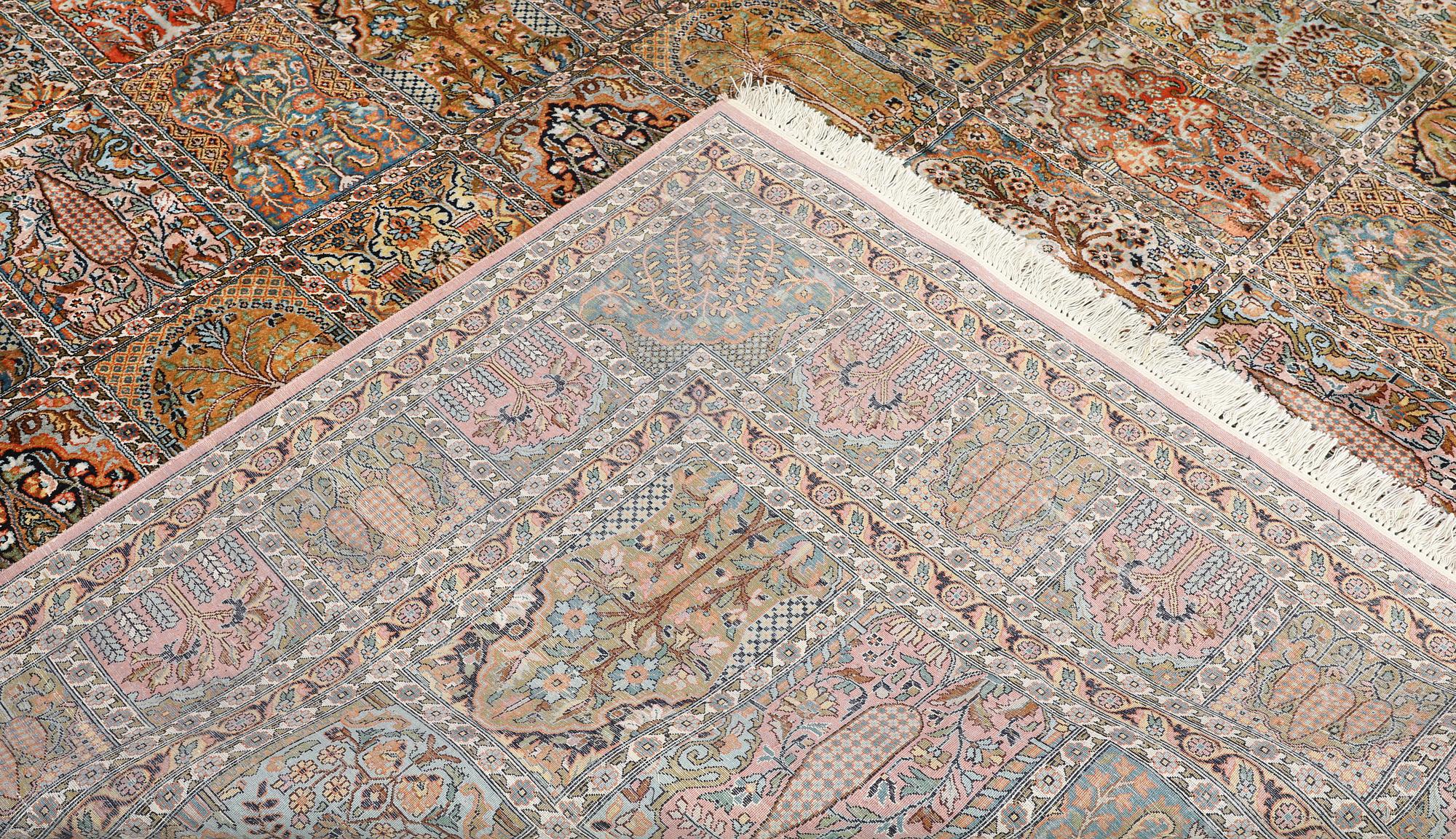 A Kashmir silk carpet, 418 x 297 cm.