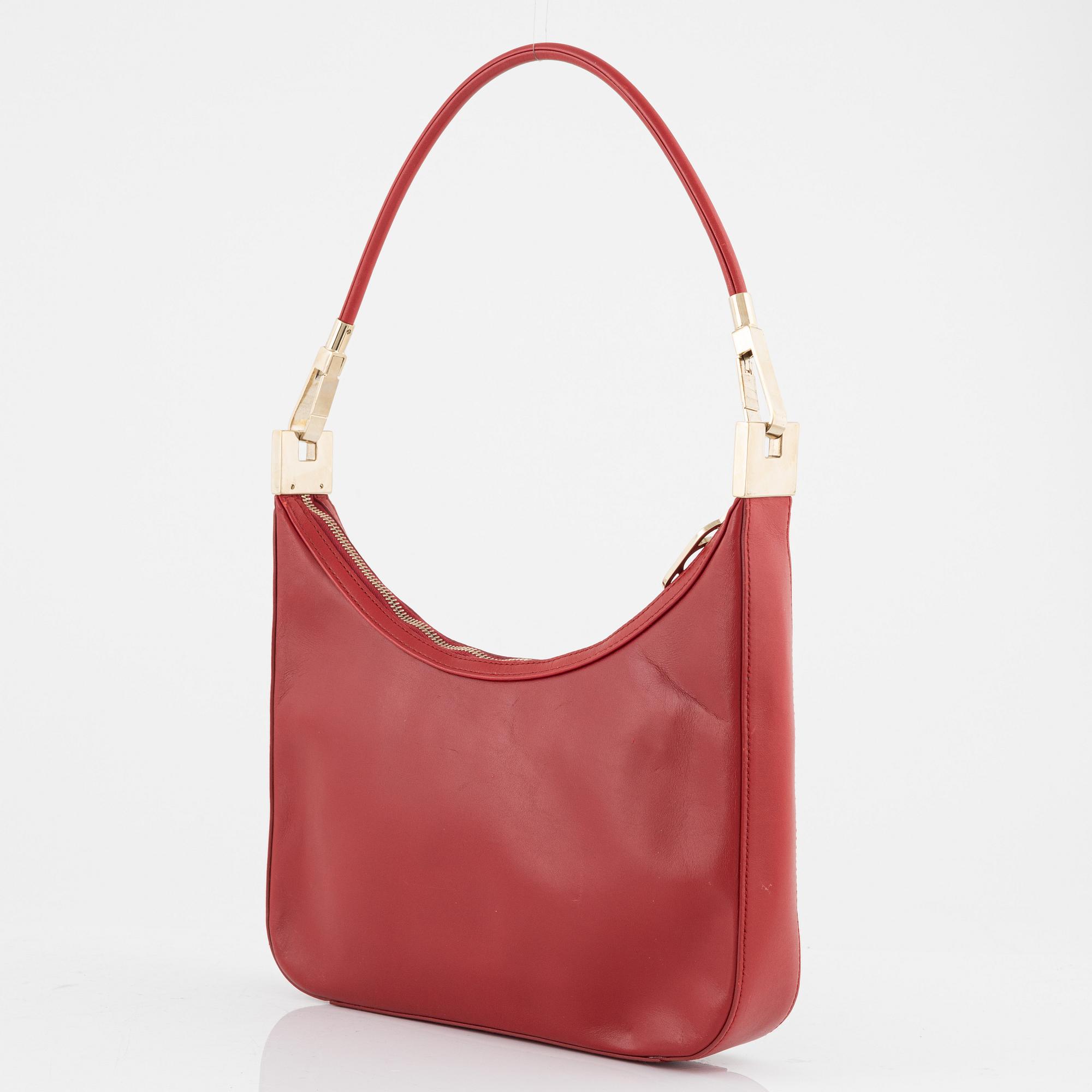 Gucci, a red leather handbag.