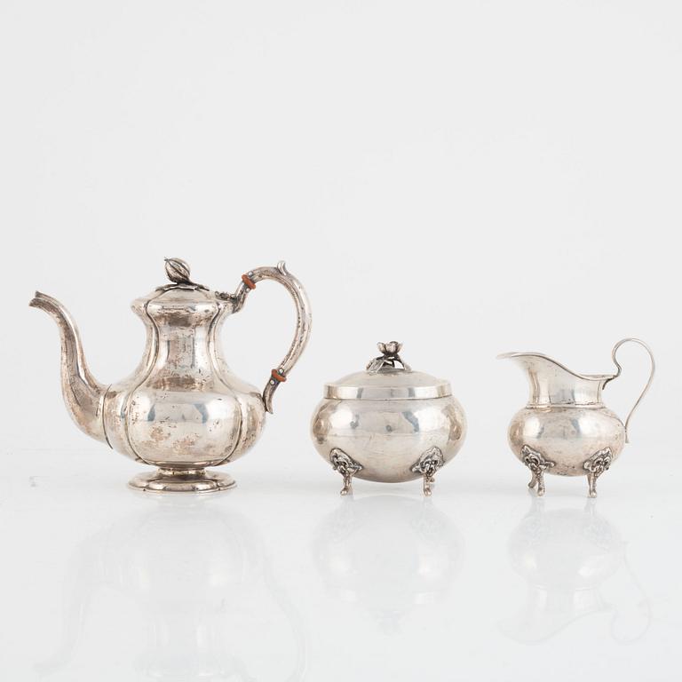 A silver coffee pot, a creamer and a sugarbowl, including S:t Petersburg, Russia 1858.