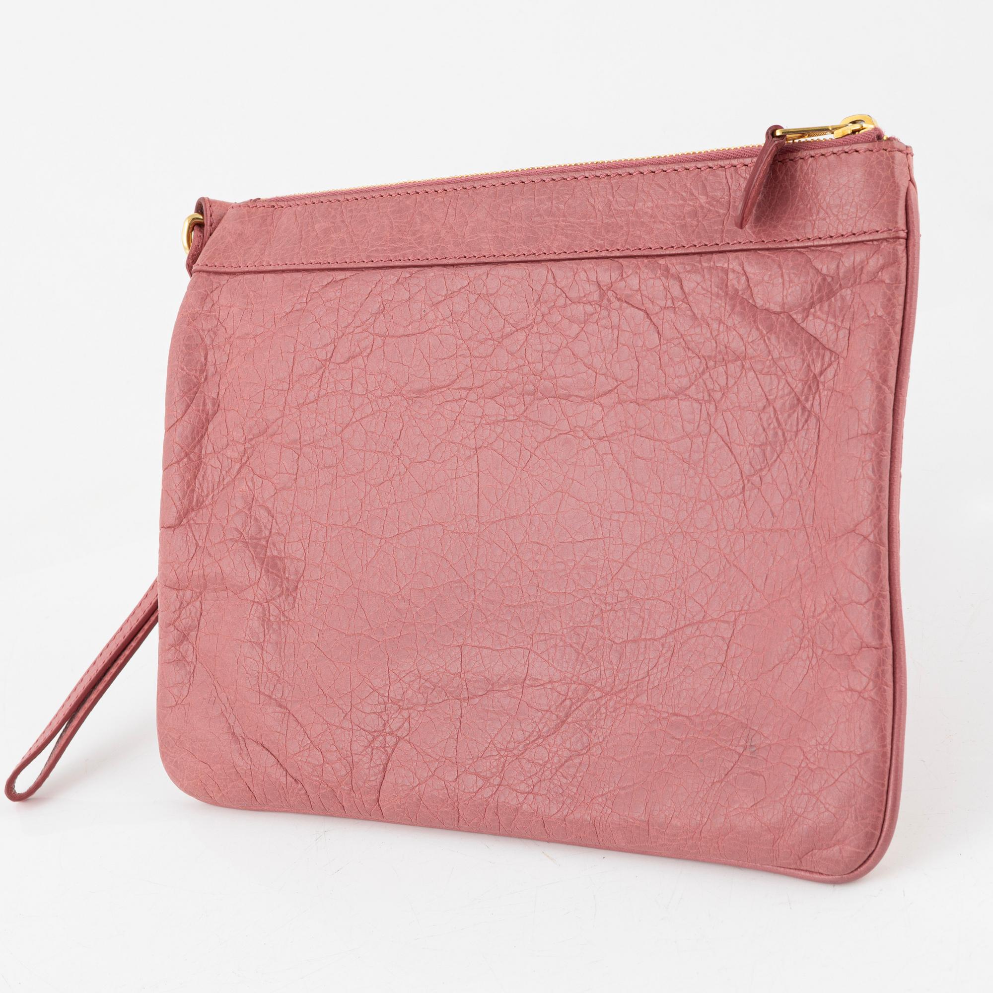 Balenciaga, a pink leather clutch.