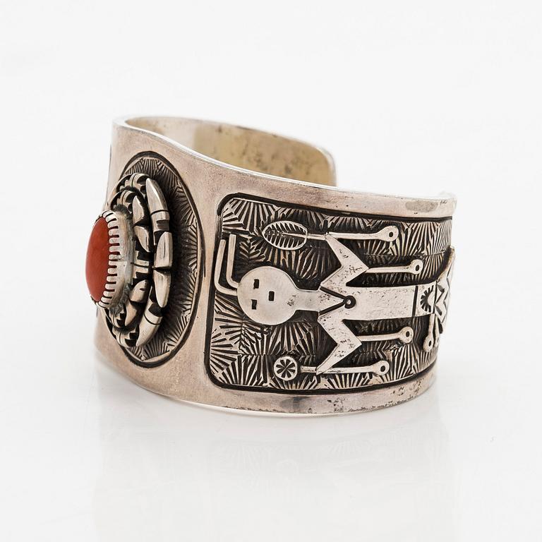 A silver bracelet with coral.