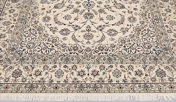 A Nain, part silk carpet, 305 x 207 cm.
