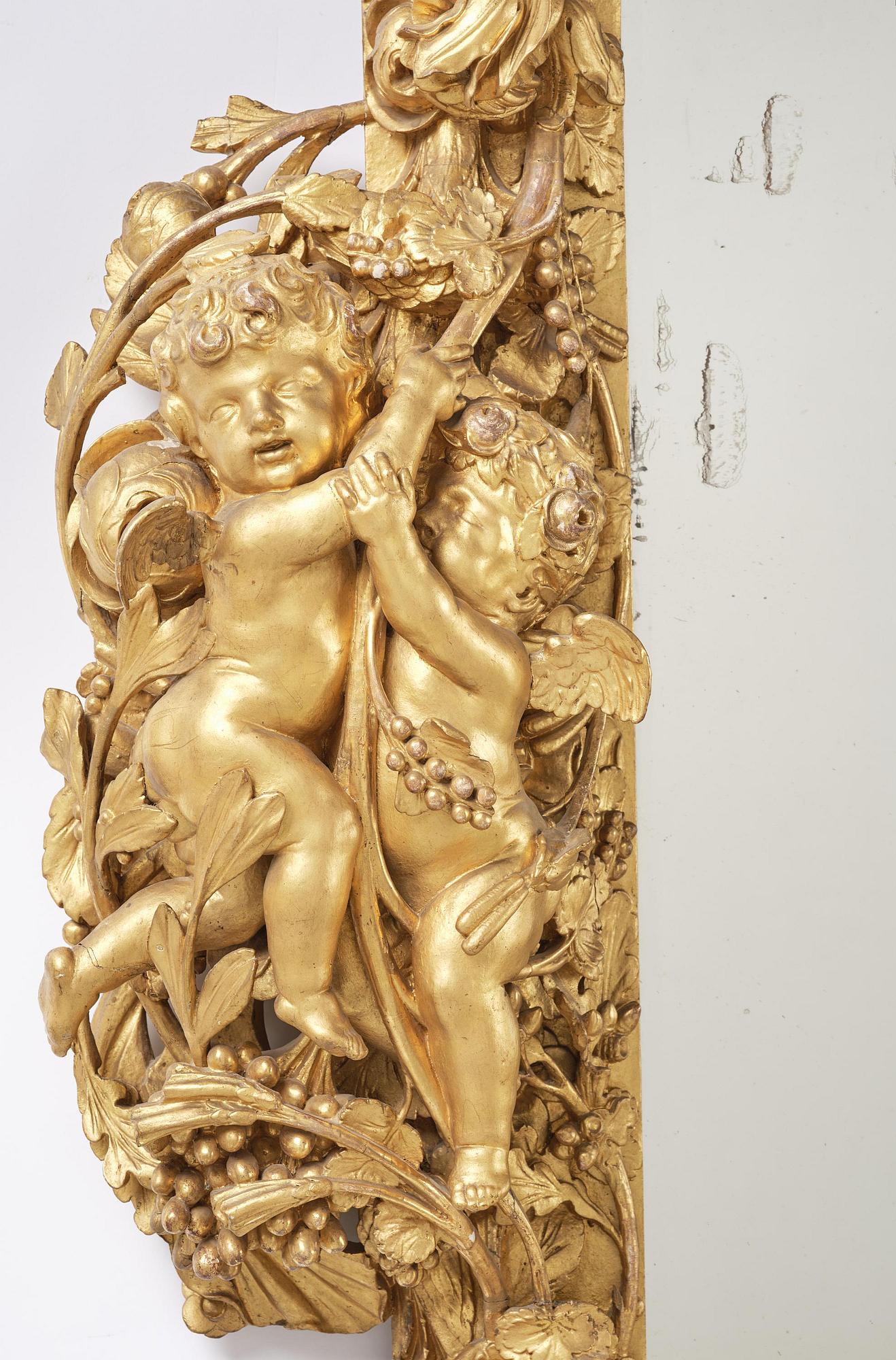 A presumably Dutch Louis XIV carved giltwood frame with mirror glass, in the style of Jean Le Pautre, late 17th century.