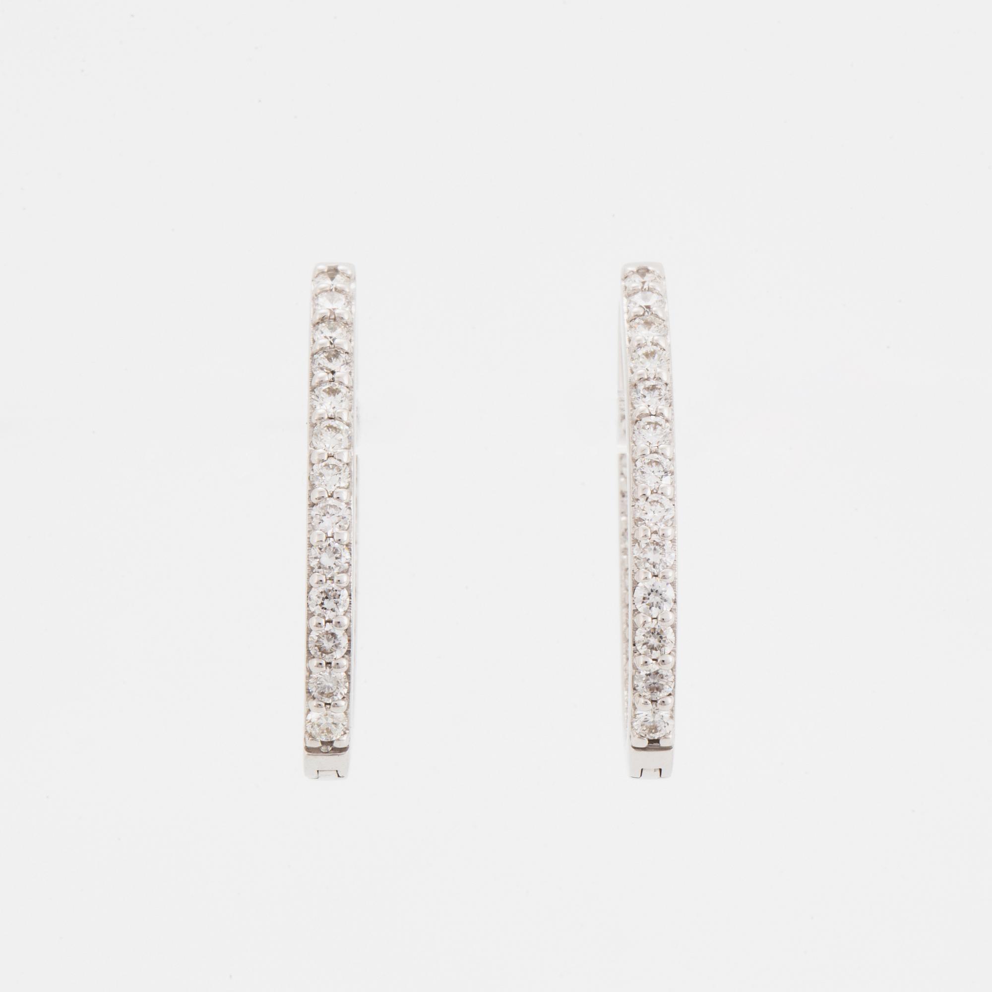 Brilliant-cut diamond hoop earrings.