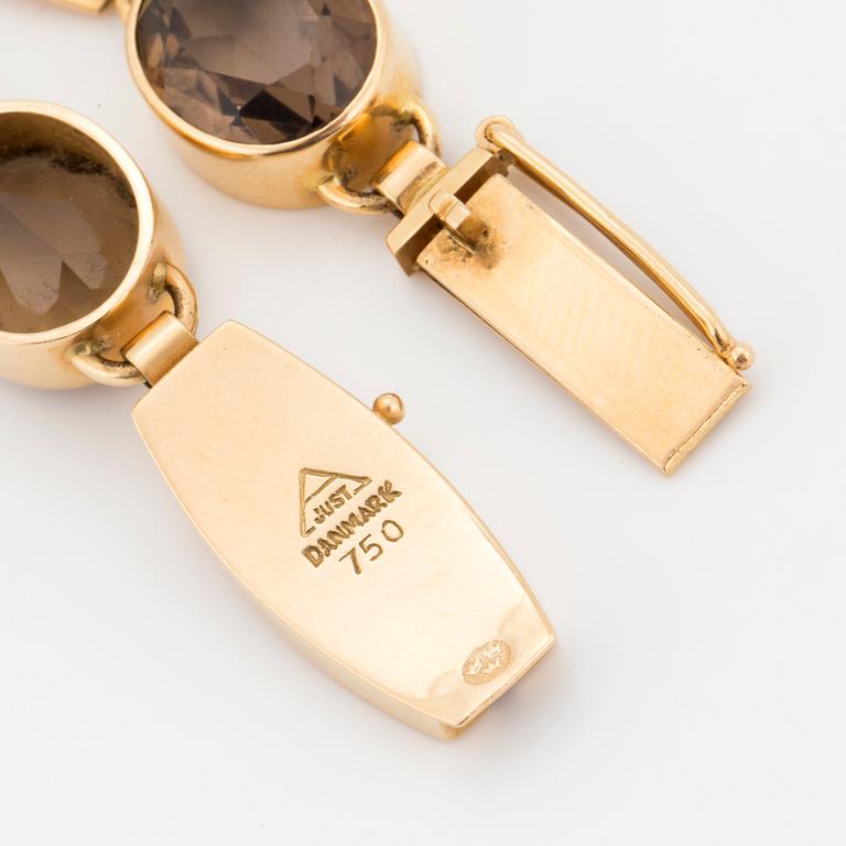 A Just Andersen 18K gold and smoky quartz bracelet.
