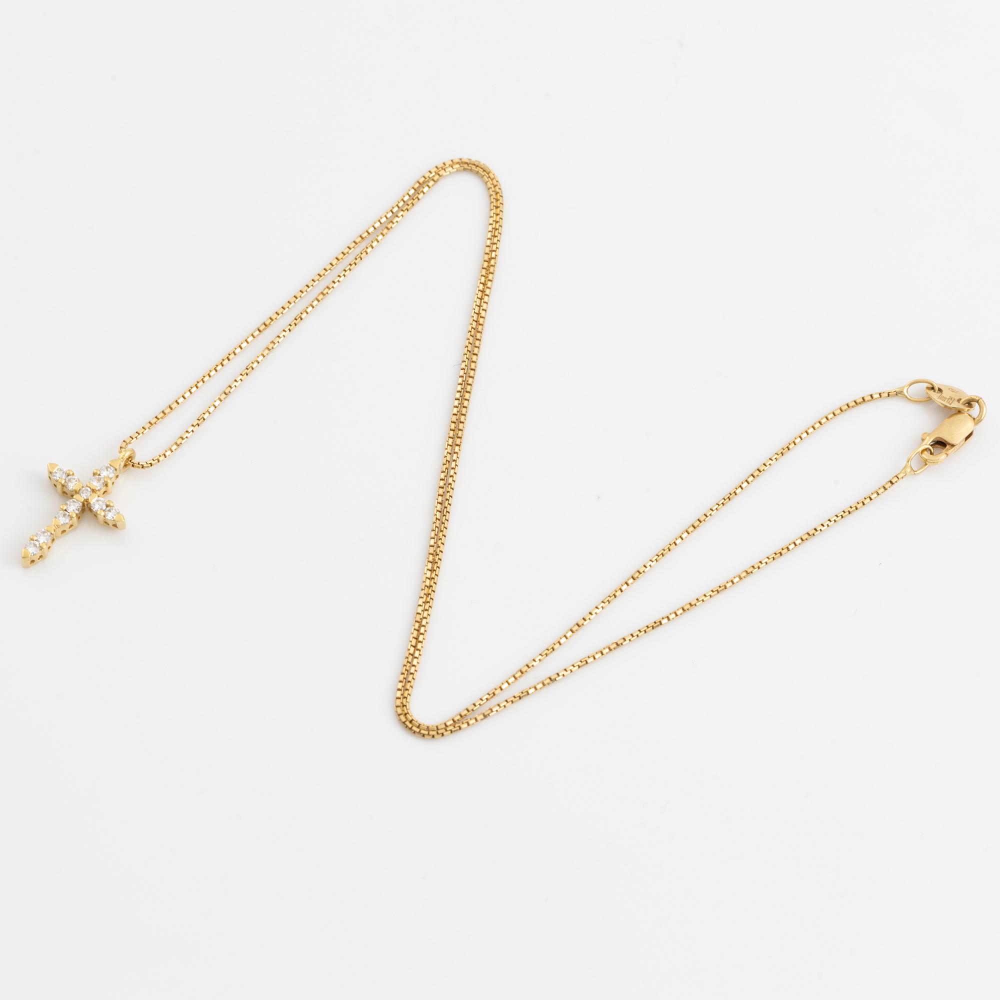 A pendant/cross 18K gold with round brilliant-cut diamonds.