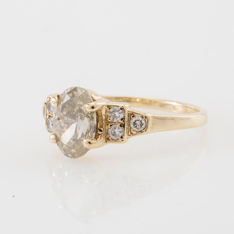 Ring 14K gold with an oval faceted diamond approximately 1.23 ct and round brilliant-cut diamonds.