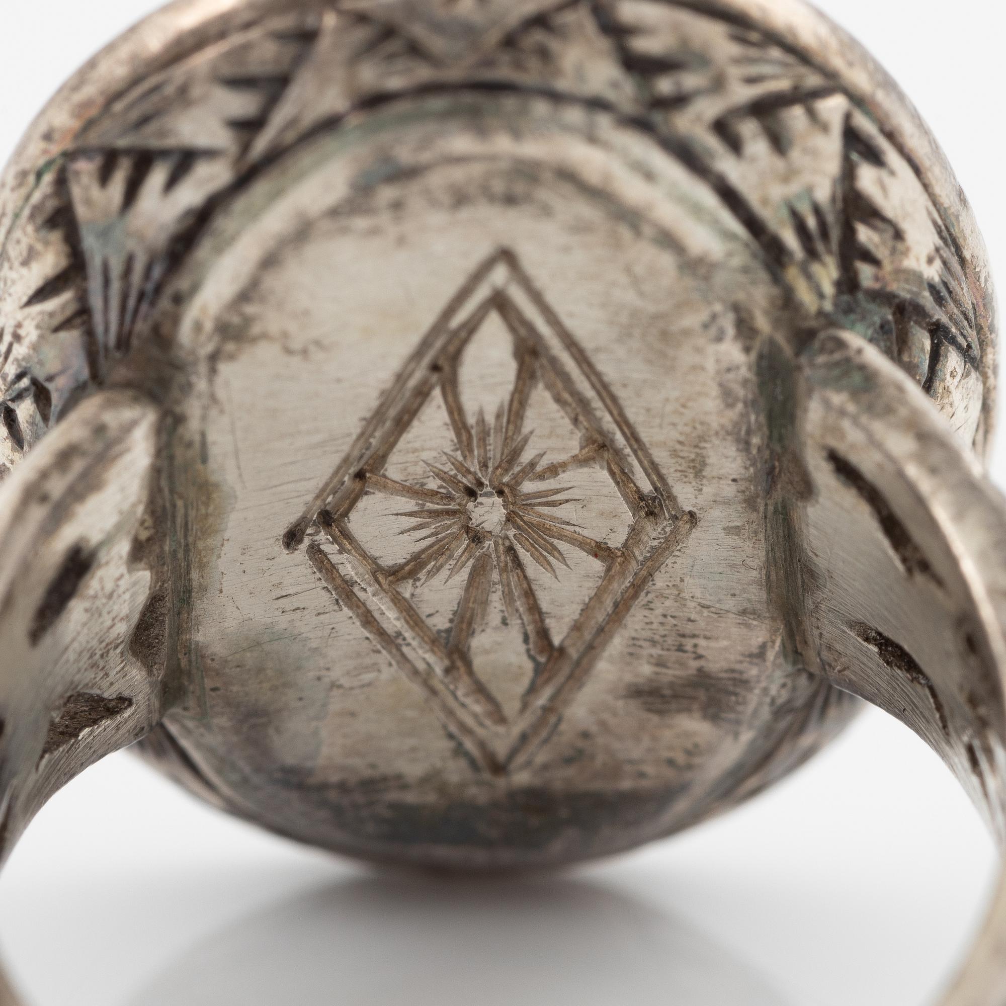 Silver ring with coral and marcasites and with black details.
