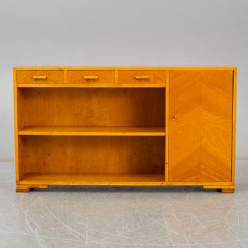 A 1930s birch and elm veneered shelf.