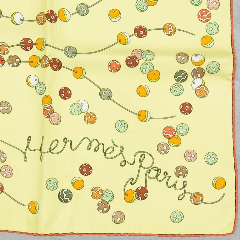 a "Dancing pearls" silk scarf by Hermès.