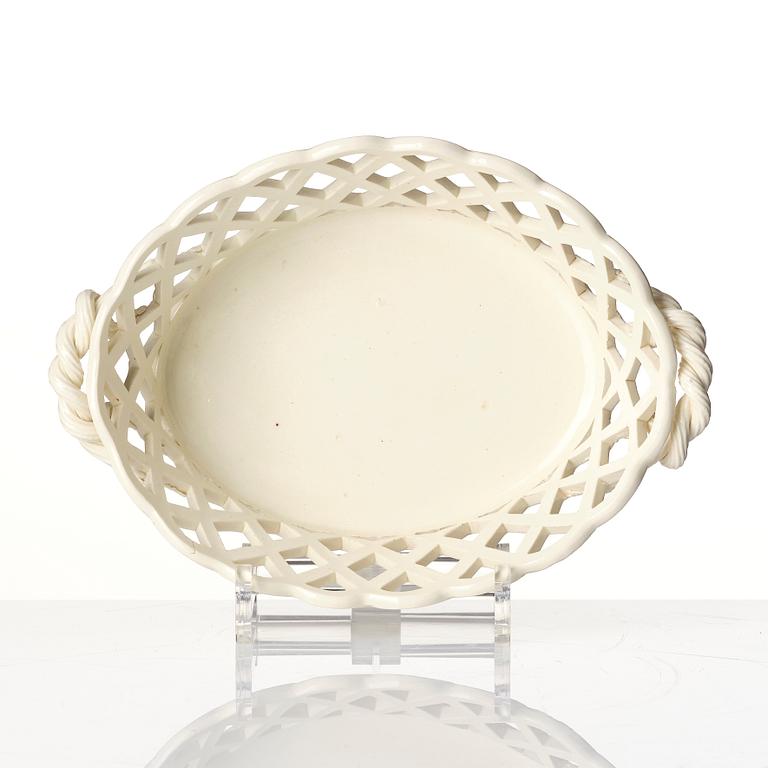 A latticed creamware chestnut basket with stand, 19th century.