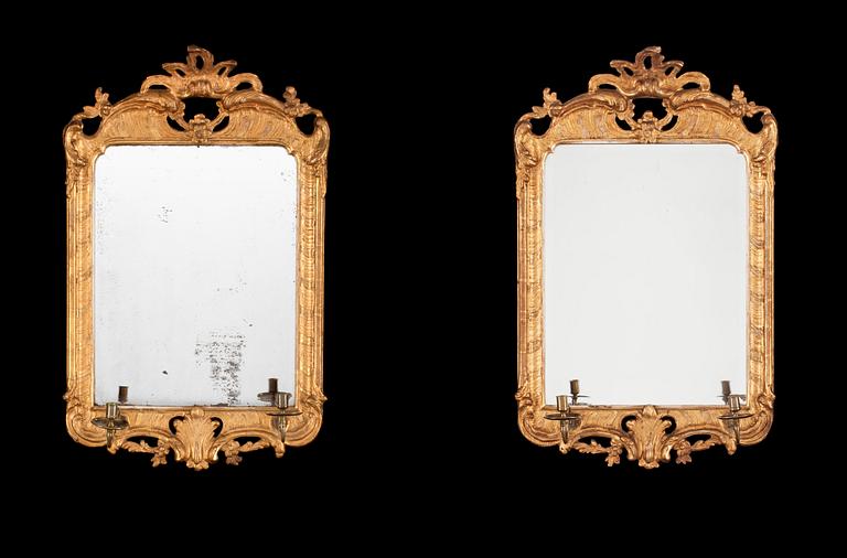 A pair of Swedish Rococo 18th century two-light girandole mirrors.