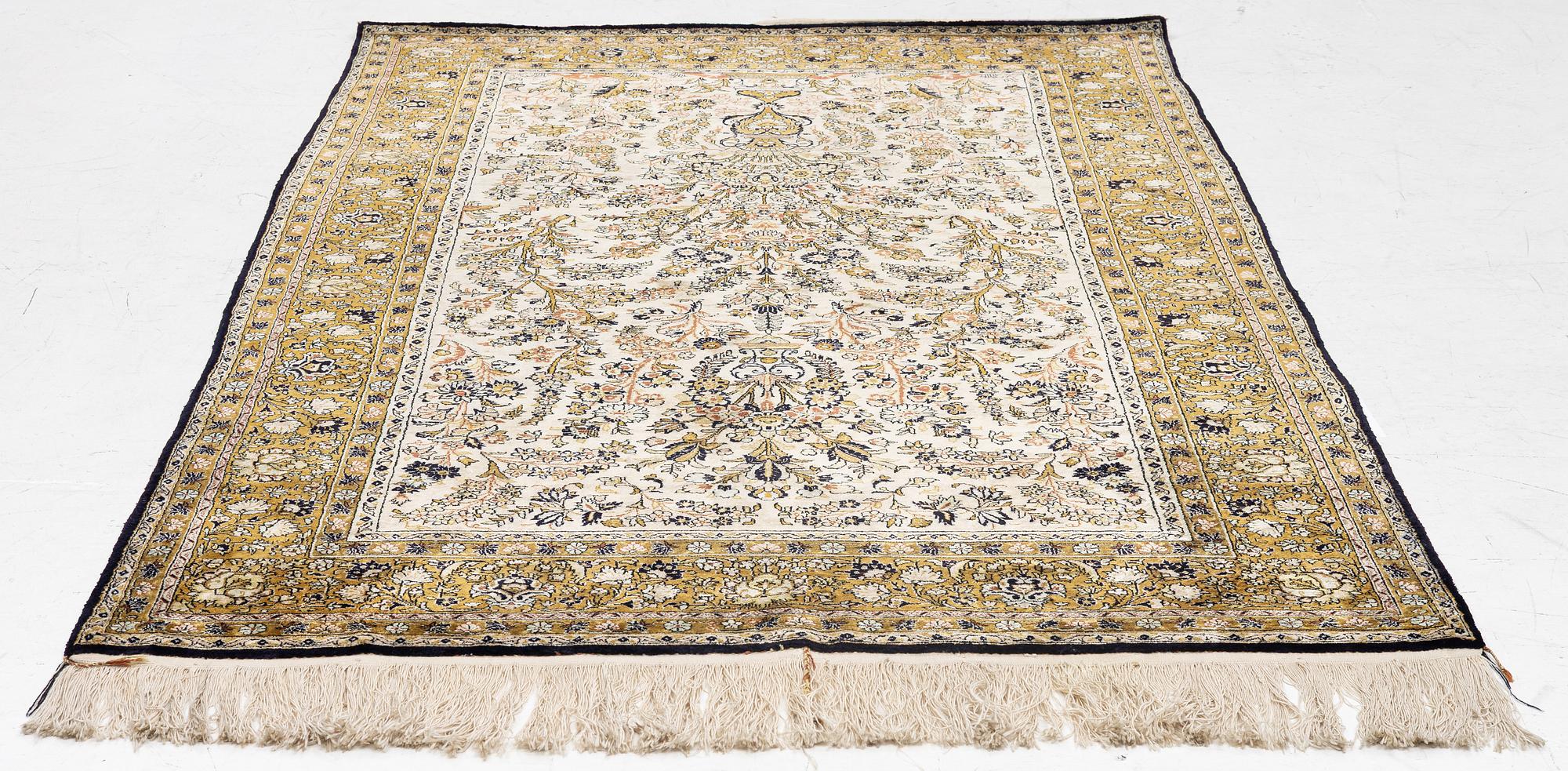 A Ghom, silk rug, c. 215 x 140 cm.