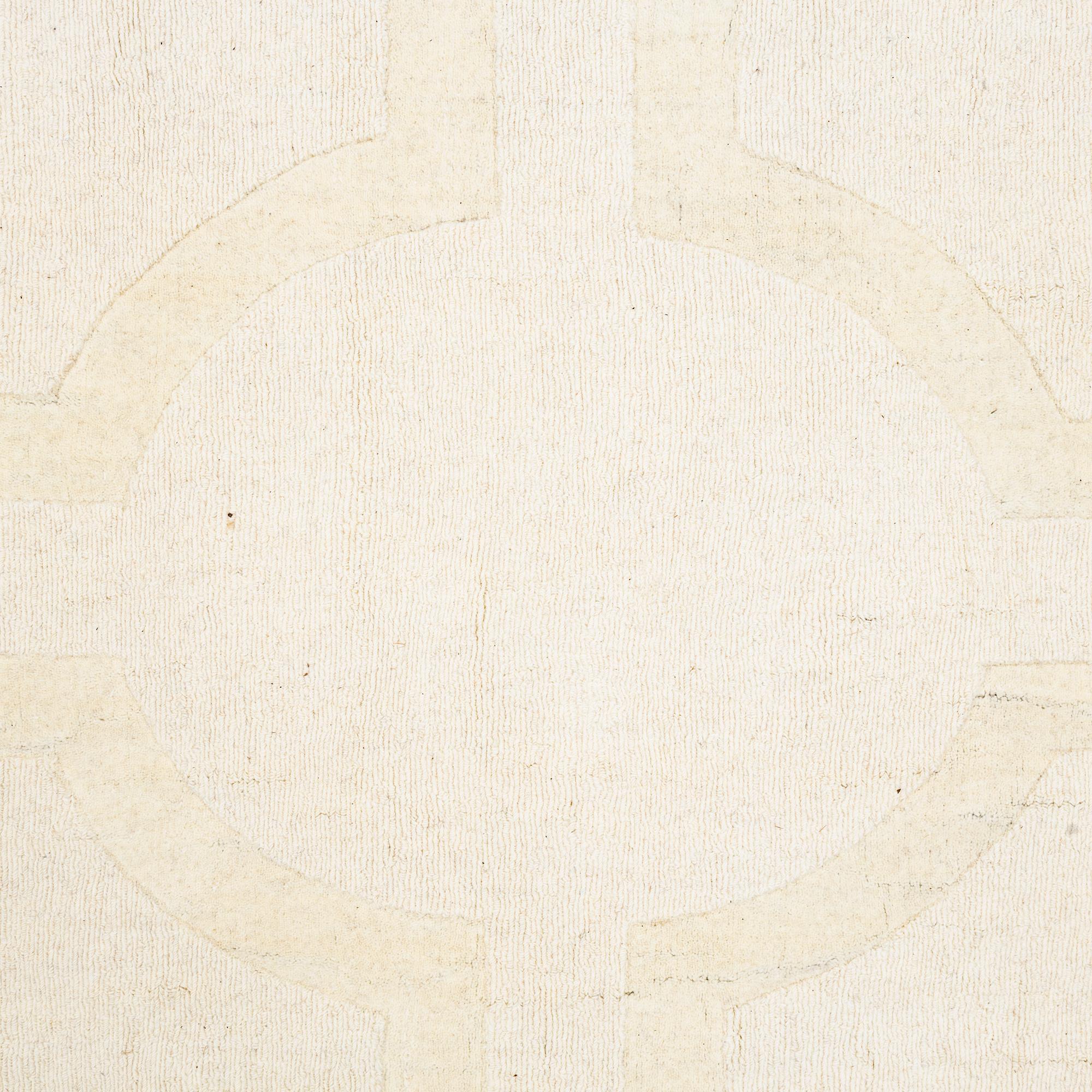 A hantd tufted carpet, 'Entrance - bone white' by Layered, ca 400 x 300 cm.