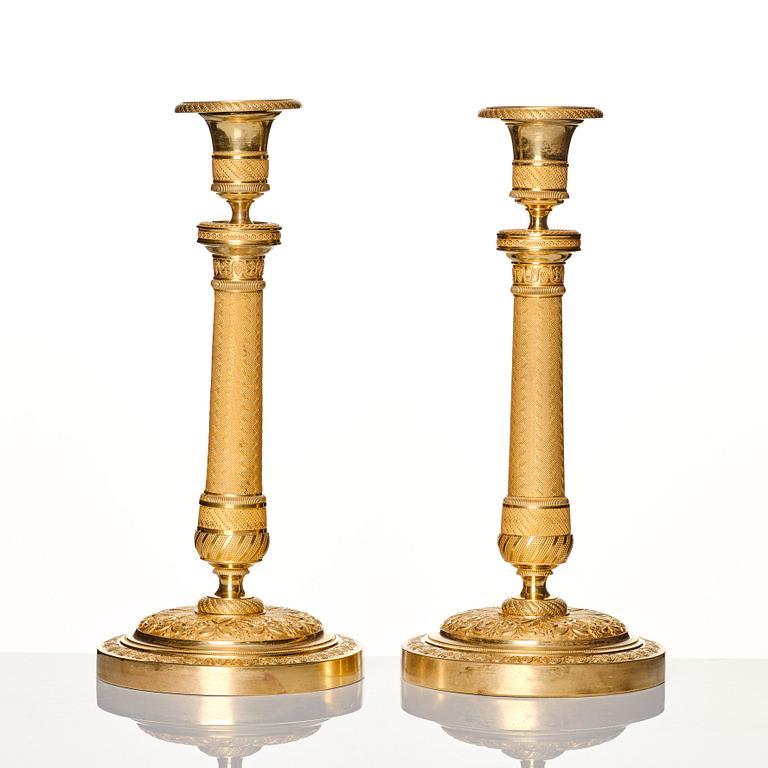 A pair of French gilded Empire candlesticks, early 19th century.