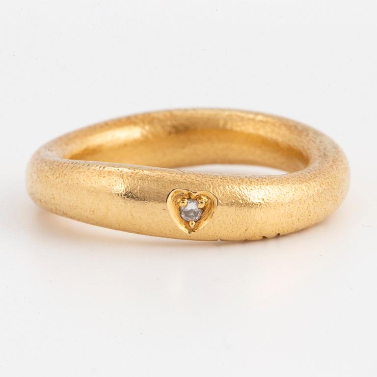 An 18K gold Ole Lynggaard ring set with a round brilliant-cut diamond.