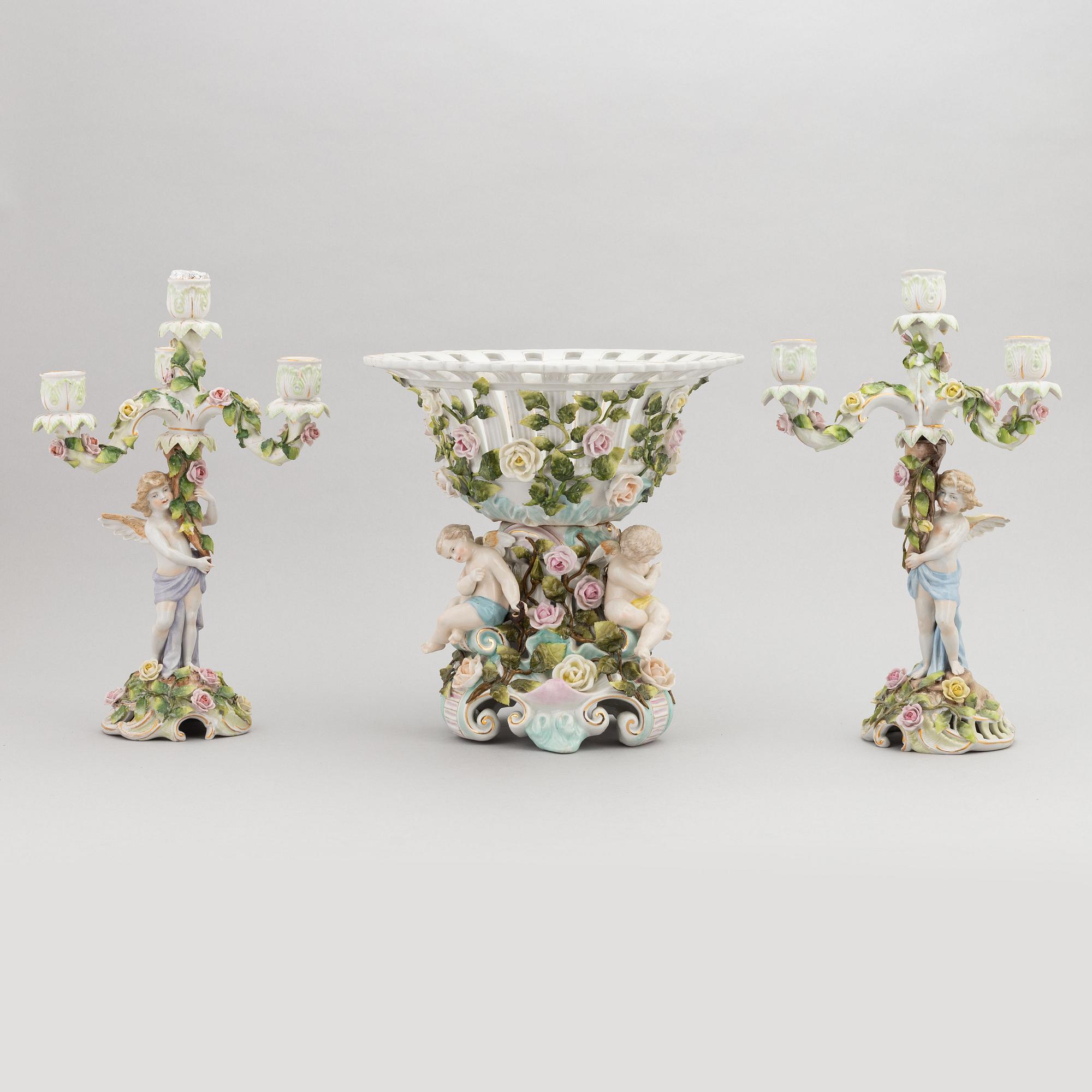 A pair of porcelain rococo style candelabra and a centerpiece bowl, Plaue, Germany, first half of the 20th century.