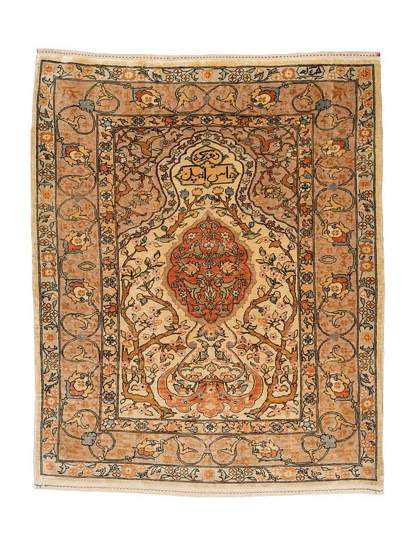 A rug, old silk Hereke, signed, ca 84,5 x 66 cm.