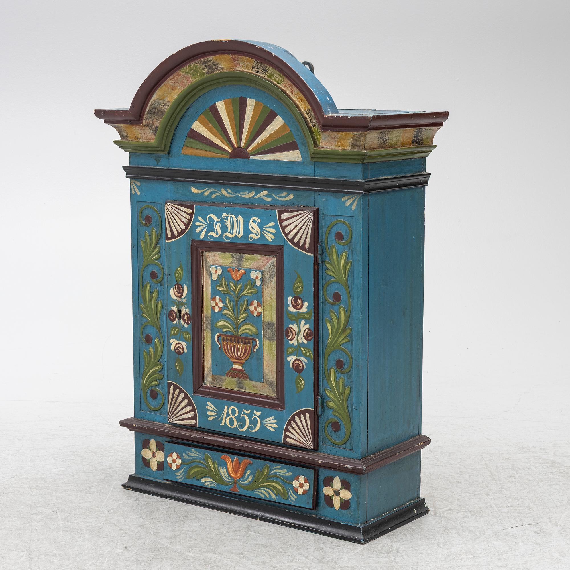 A 19th century folk art hanging cabinet.