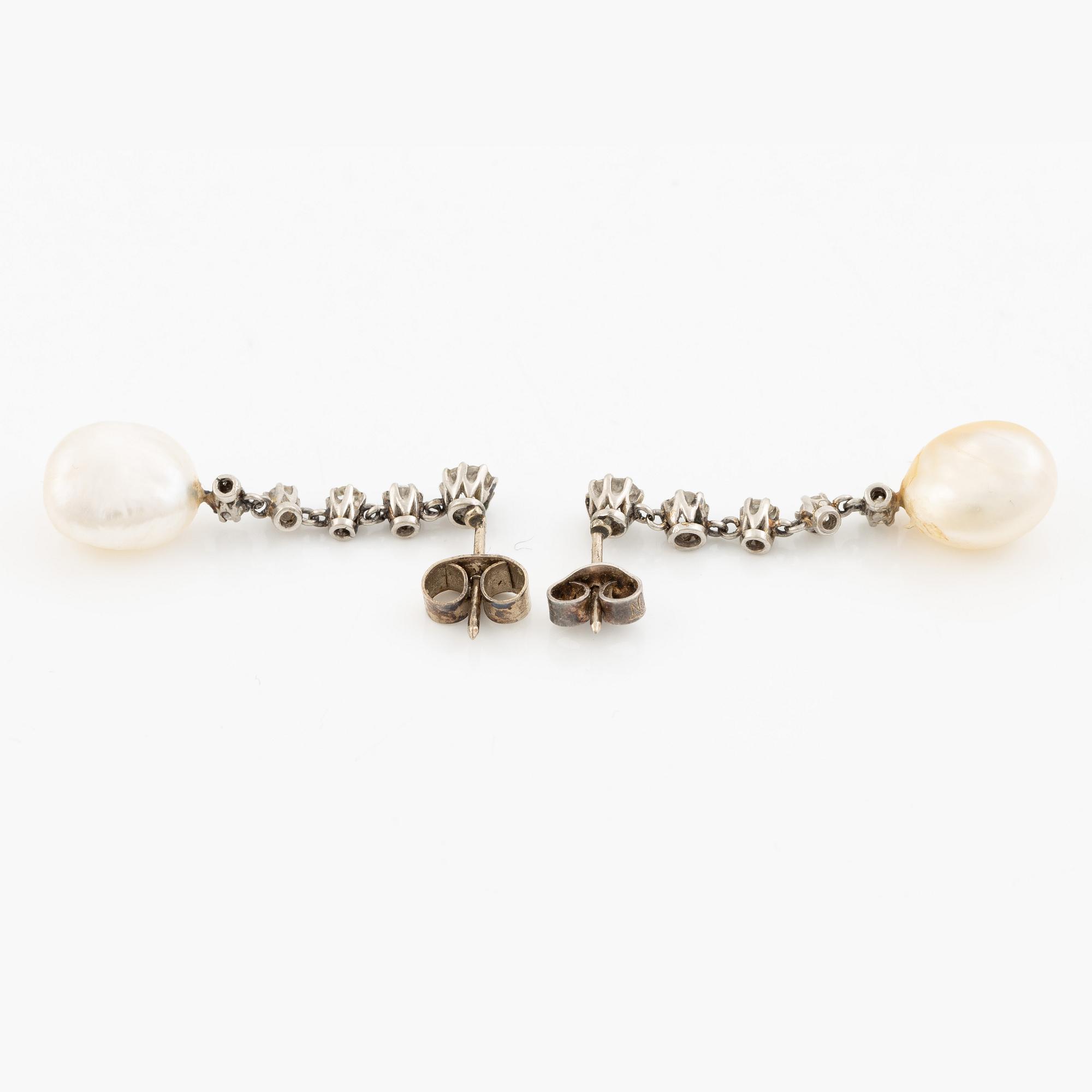 A pair of  earrings in white gold with pearls and old-cut diamonds.
