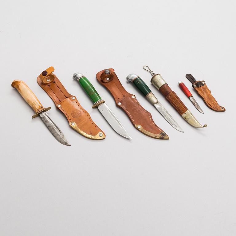 A set of four puukko knives and leather sheats, marked Olympia Helsinki -52.