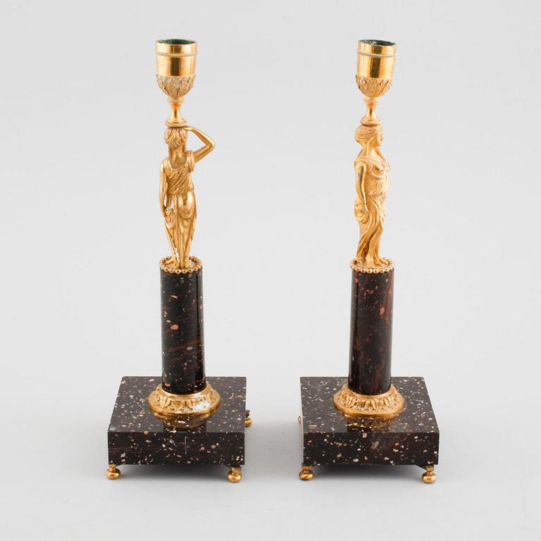 A pair of late gustavian early 19th century porphyry and ormolu candlesticks.