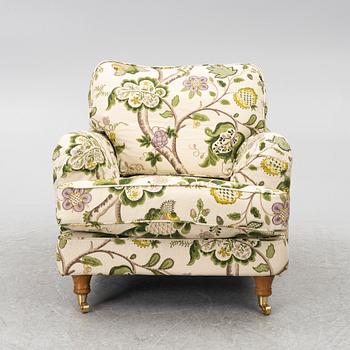 A 'Howard' armchair with footstool, Englesson.