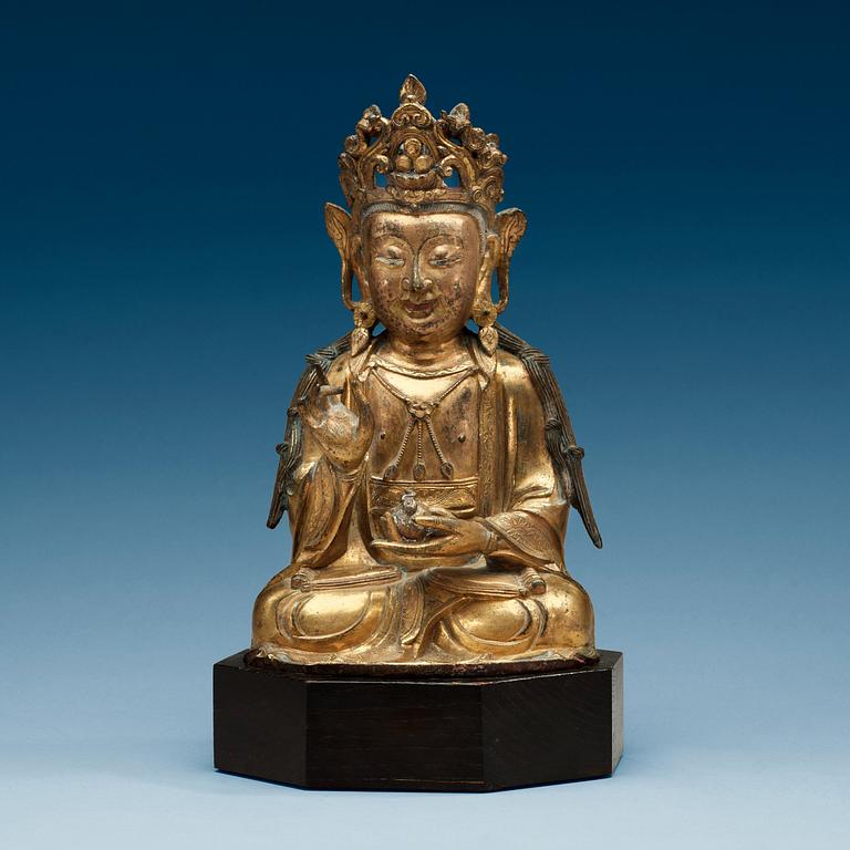 A  gilt-bronze figure of a seated Guanyin, Ming dynasty (1368-1644).