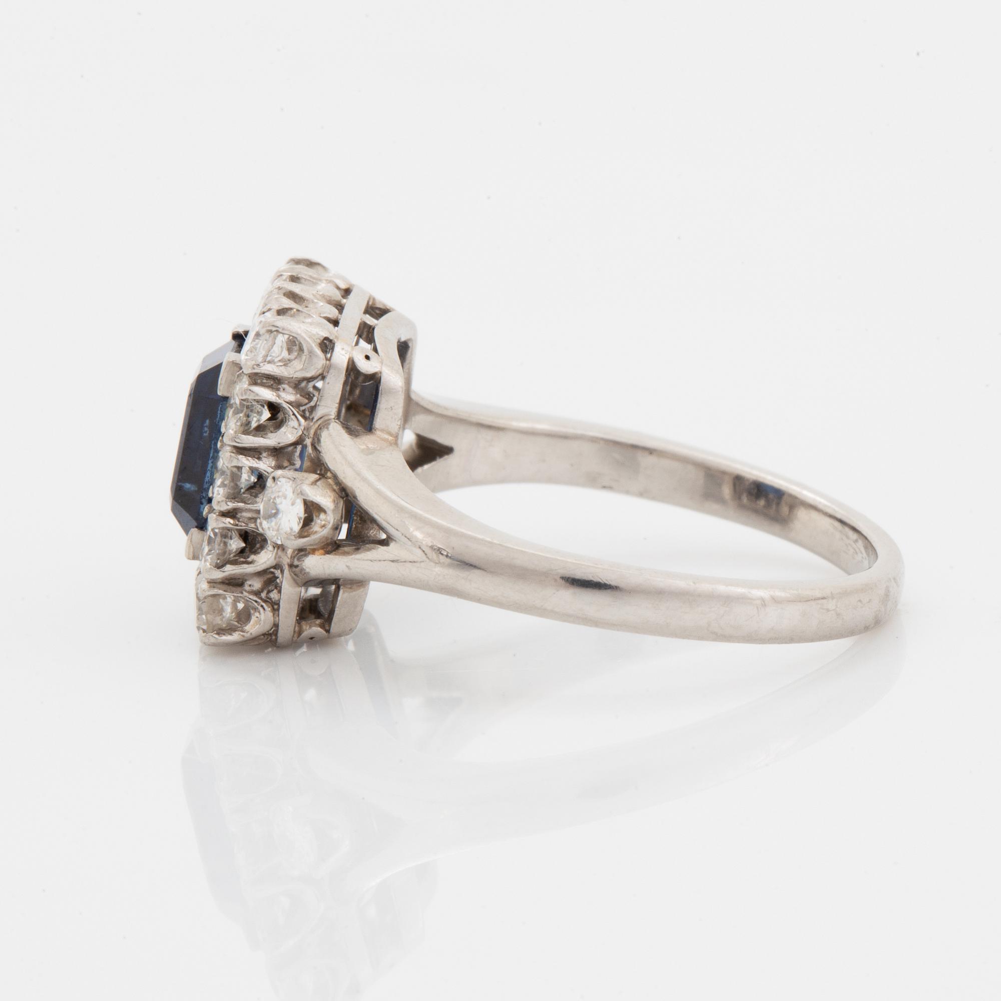 A platinum ring set with a faceted sapphire.