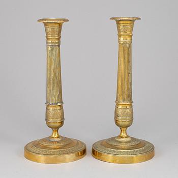 A pair of empire bronze candlesticks, first half of the 19th century.