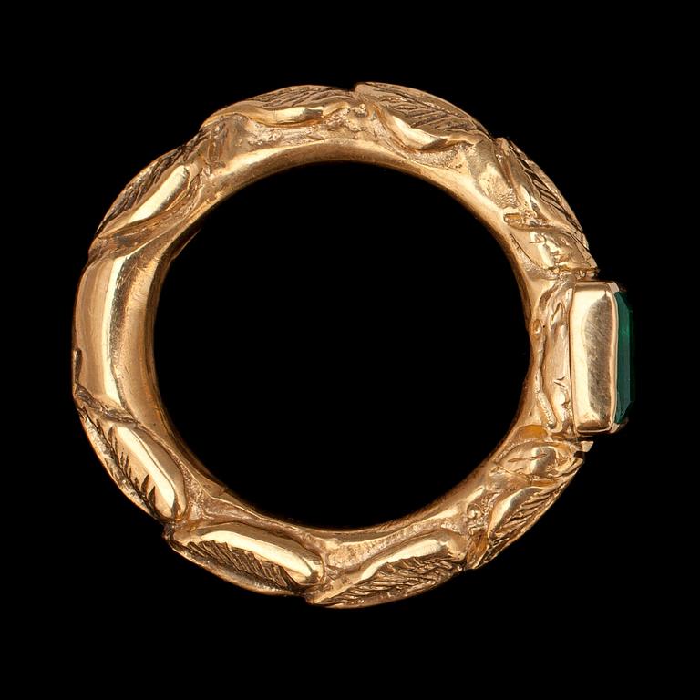 An emerald and gold ring.