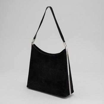 Salvatore Ferragamo, a black suede handbag.