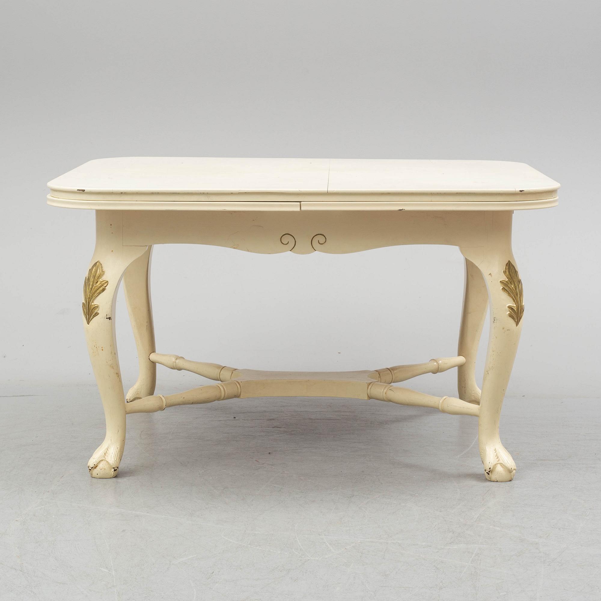 A dining table and six chairs, rococo style, mid 20th century.