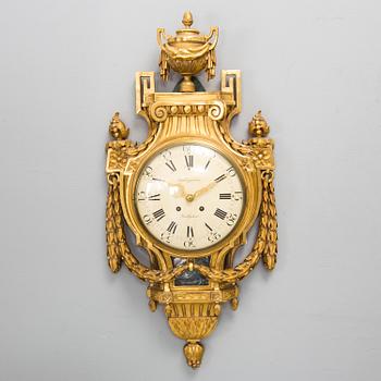 A wall clock in gustavian style, marked Rob. Engström, Stockholm.