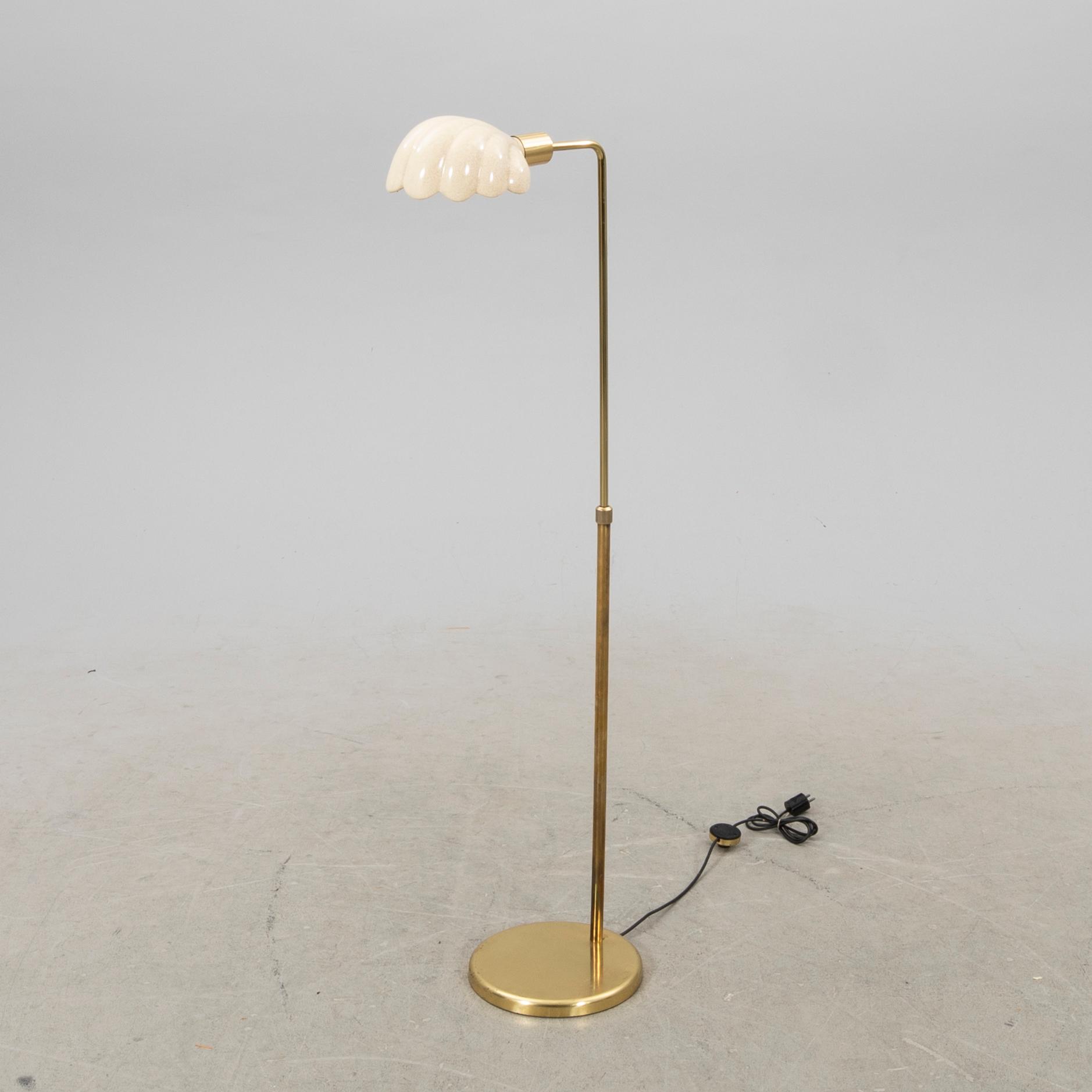 A late 20th Century floor lampp with a shell formed shade.