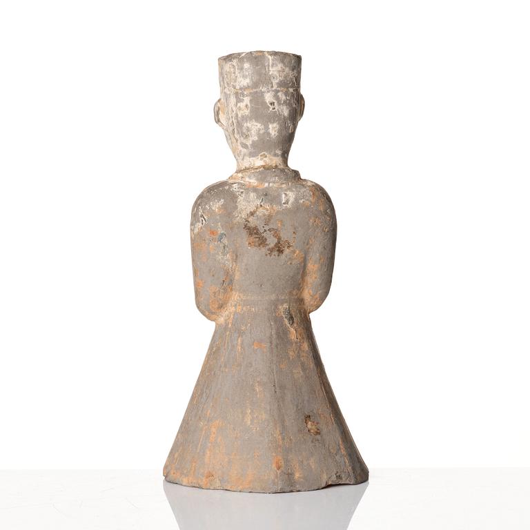 A pottery figure of a standing male figure, Han dynasty (206 BC - 220 AD).