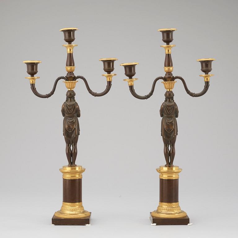 A pair of Empire early 19th century three-light candelabra.