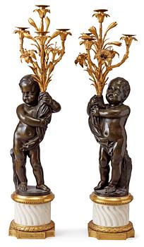 607. A pair of Louis XVI-style 19th century gilt and patinated bronze marble four-light candelabra.