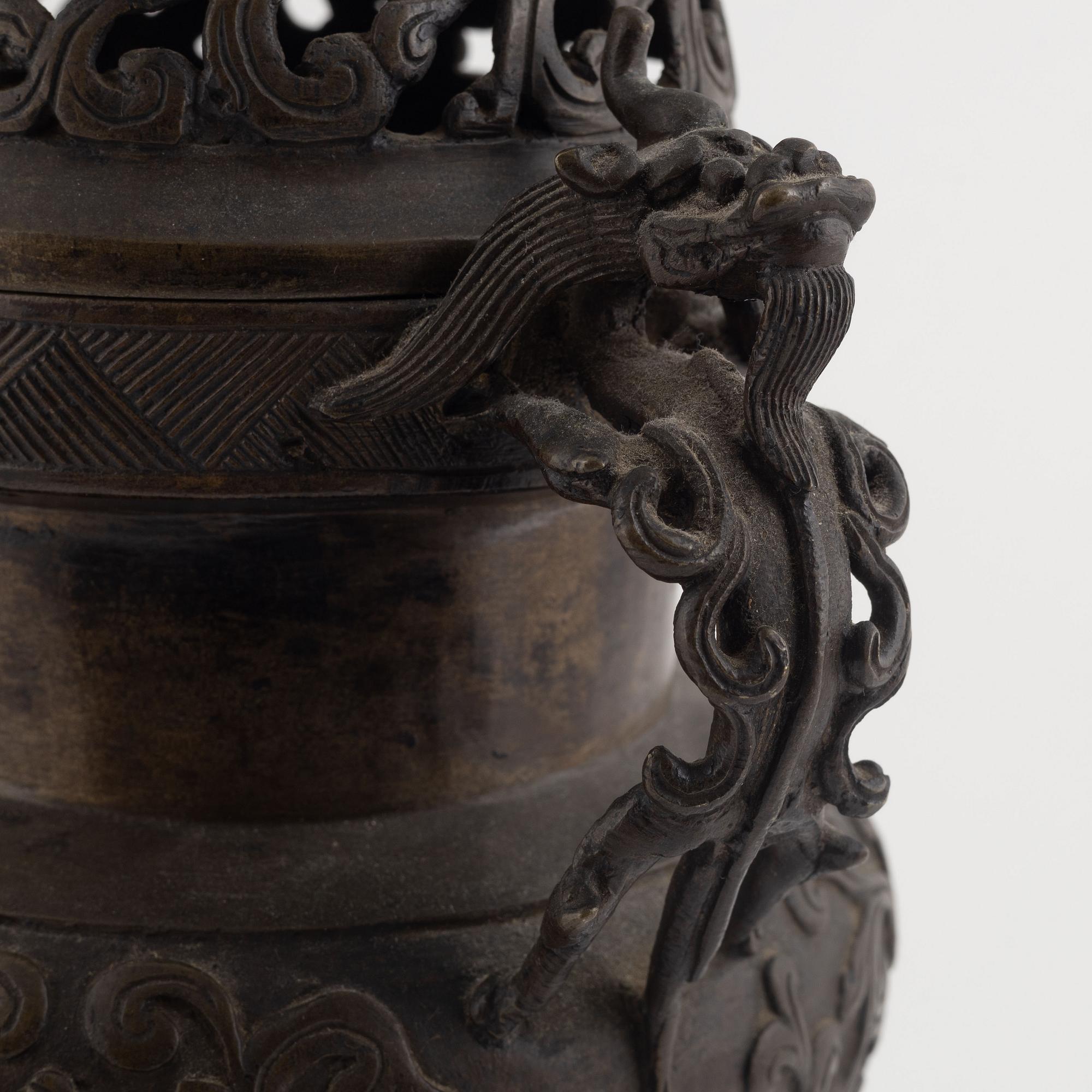 A tripod bronze censer with cover, Qing dynasty, 19th century.