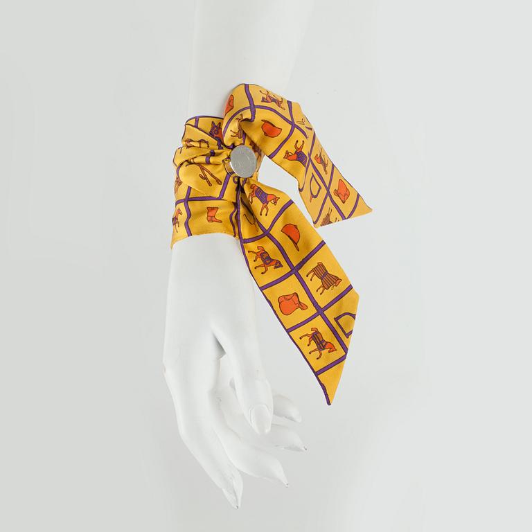 HERMÈS, two silk braclets with palladiumcovered locks.