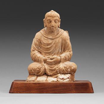 118. A stucco figure of a seated buddha, Gandhara, 2nd/3rd Century.