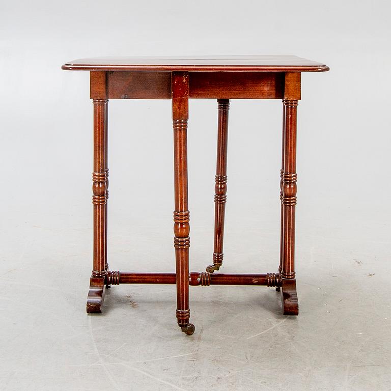 A 20th century English mahogany folding table.